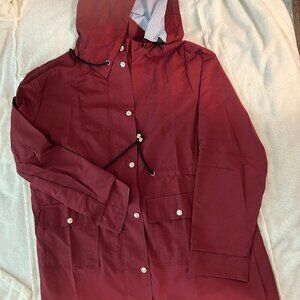 New red ladies lightweight raincoat,  blue & white striped lining. Size 12